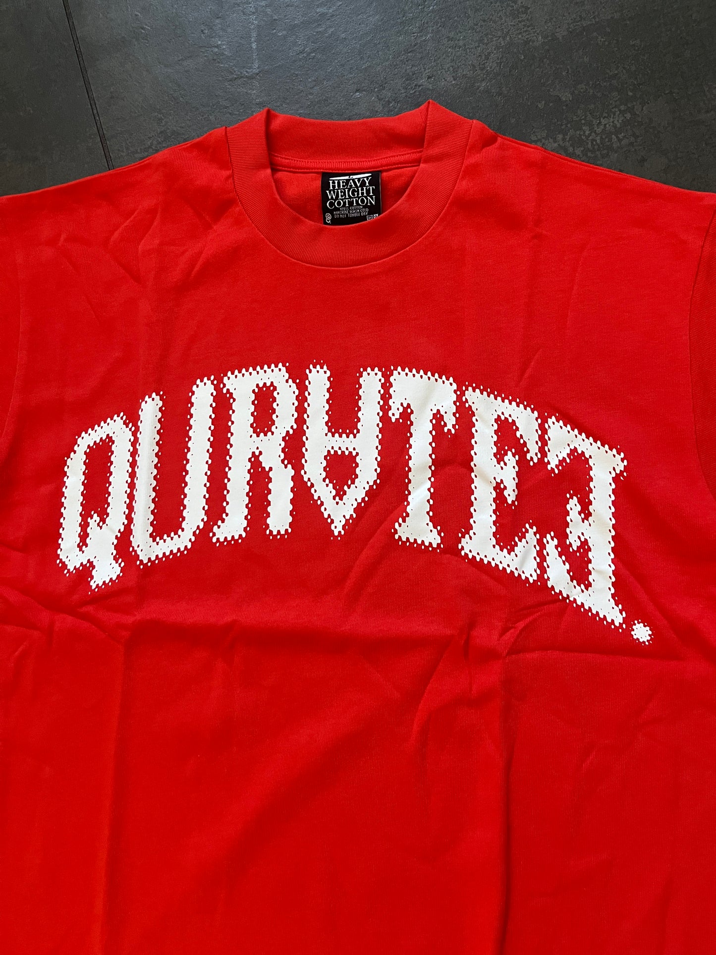 Quratee orange spell out tee